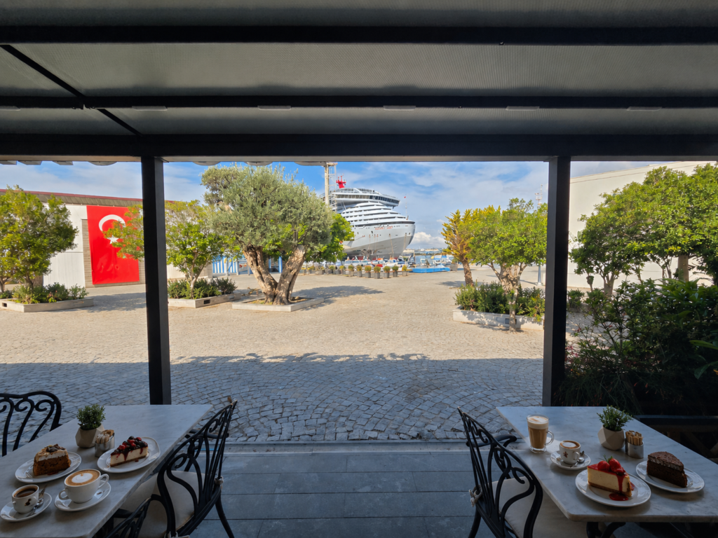 CAFE DUO BODRUM CRUISE PORT is a stylish café located near the Bodrum Cruise Port, welcoming international cruise passengers and tourists arriving from Greek islands like Kos. The café offers premium coffee, cappuccino, espresso, cheesecake, desserts, breakfast, sandwiches, and relaxing seating with a modern atmosphere close to Bodrum Castle and the marina. Ideal for tourists looking for quality coffee, quick snacks, free WiFi, and a comfortable stop during their Bodrum shore excursion.