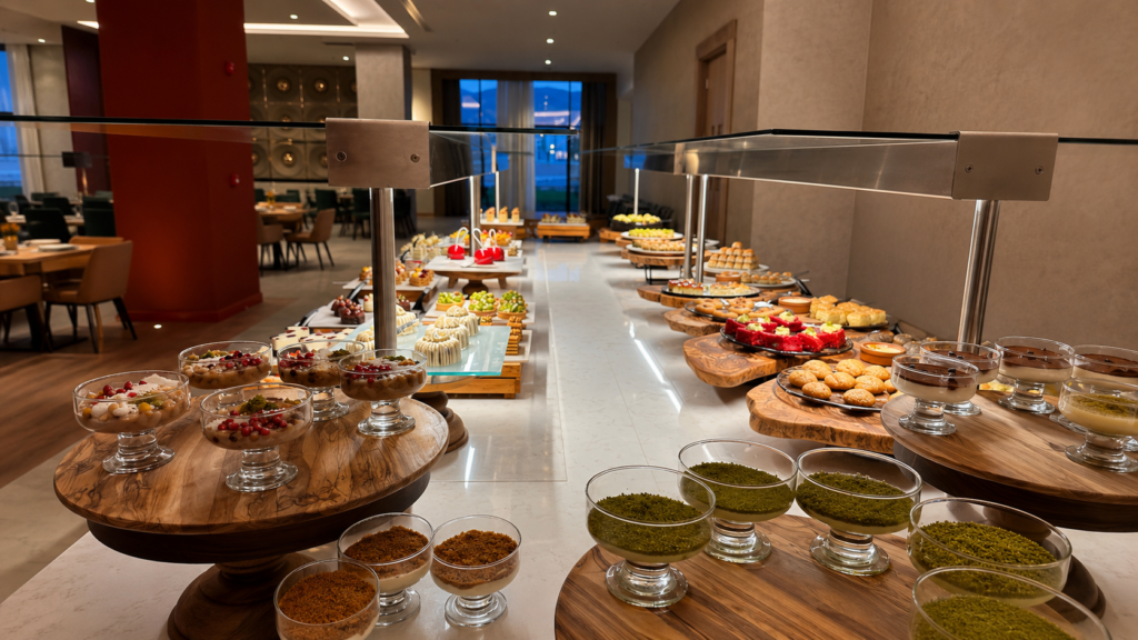 Luxury dessert buffet at Sinnada Resort & Thermaland featuring handcrafted cakes, Turkish desserts, pastries, chocolate treats, and premium sweet delicacies in an elegant restaurant.