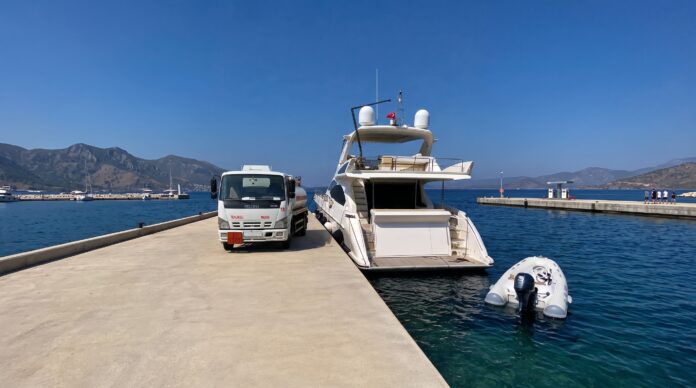 Yacht receiving fuel delivery at a marina in Bodrum, Turkey.